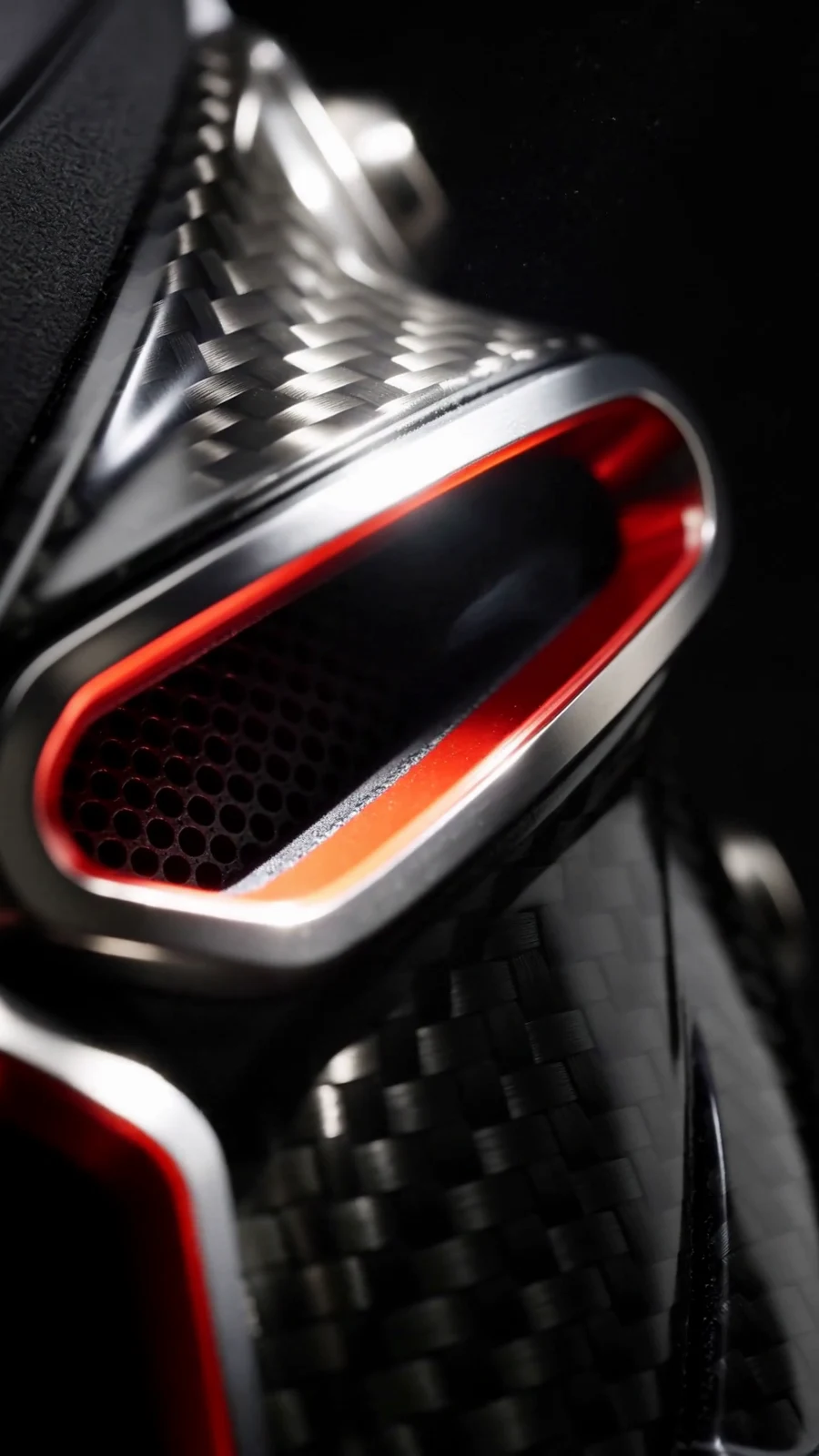 Detailed carbon-fiber weave and red-edged AeroNED vent.